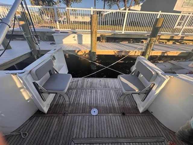 Slide: The Image of 2016 Beneteau Swift Trawler 30, docked with open seating area, wooden deck. - 20