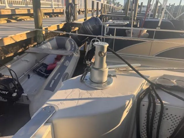 Slide: The Image of 2016 Beneteau Swift Trawler 30 docked with inflatable boat nearby. - 21
