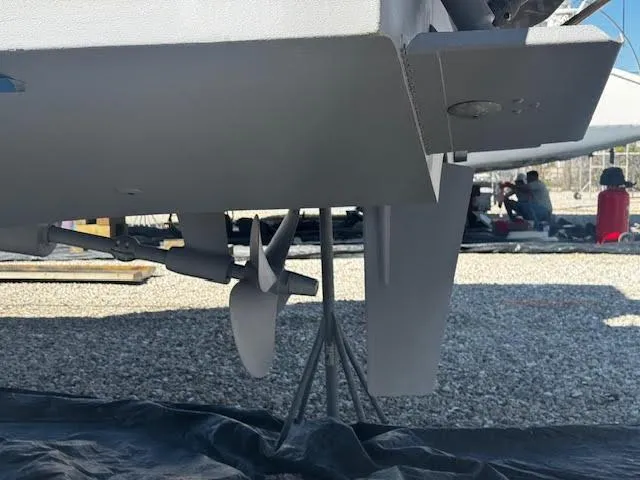 Slide: The Image of 2016 Beneteau Swift Trawler 30 propeller and rudder detail on gravel surface. - 26