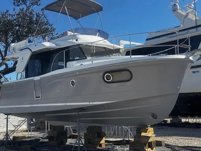 Slide: The Image of 2016 Beneteau Swift Trawler 30 on stands, side view, outdoors. - 35
