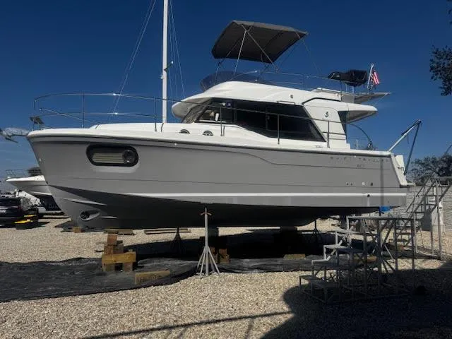 Slide: The Image of 2016 Beneteau Swift Trawler 30 on dry dock, side view, under clear blue sky. - 36