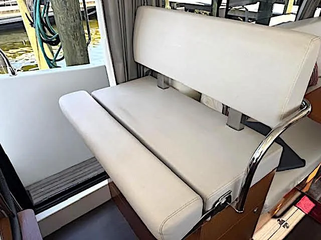 Slide: The Image of 2016 Beneteau Swift Trawler 30 interior seating with beige upholstery and chrome accents. - 41