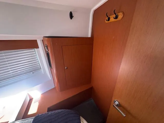 Slide: The Image of Interior of 2016 Beneteau Swift Trawler 30 with wooden cabinetry and hooks. - 7