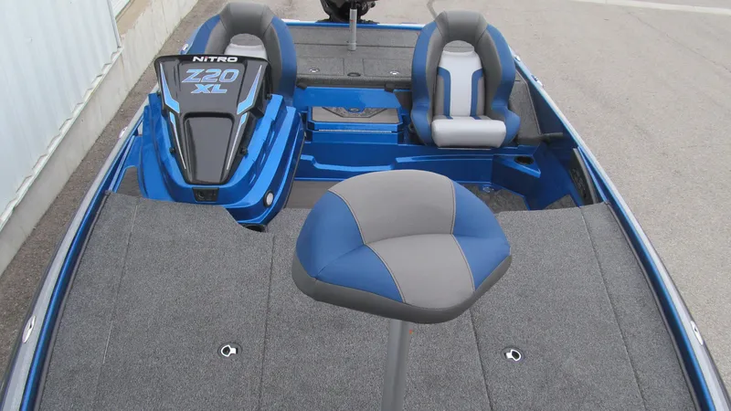 Slide: The Image of 2025 Nitro Z20 XL Pro boat interior with blue and gray seating. - 10
