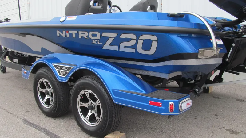 Slide: The Image of 2025 Nitro Z20 XL Pro boat, blue, on a trailer, side view. - 12