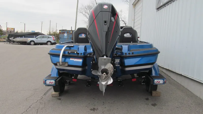 Slide: The Image of 2025 Nitro Z20 XL Pro boat, rear view, parked on pavement. - 3