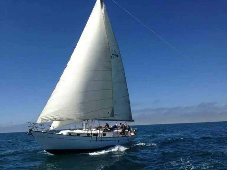 Slide: The Image of 1979 C & L Explorer Center Cockpit Cutter sailing on open sea under clear blue sky. - 1