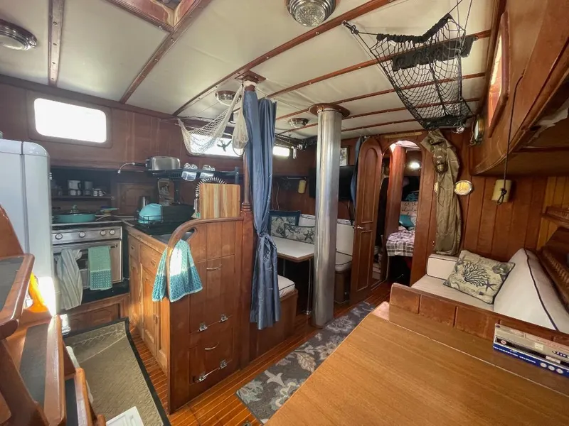 Slide: The Image of 1979 C & L Explorer Center Cockpit Cutter interior with wood finish and cozy living space. - 10