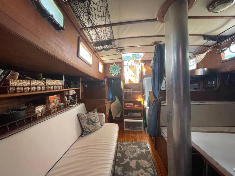 Slide: The Image of Interior of 1979 C & L Explorer Center Cockpit Cutter, featuring cozy seating and wooden decor. - 12