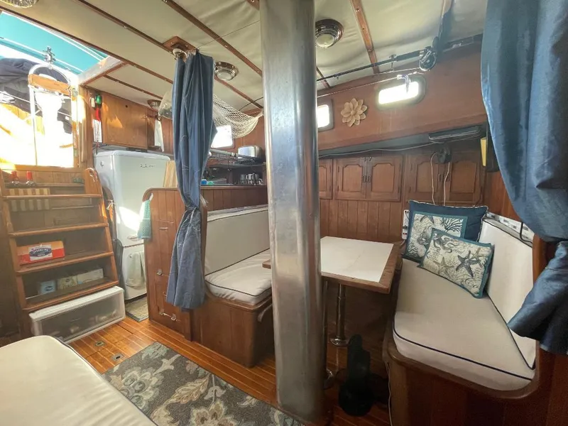 Slide: The Image of 1979 C & L Explorer Center Cockpit Cutter interior with cozy seating and wooden finishes. - 13