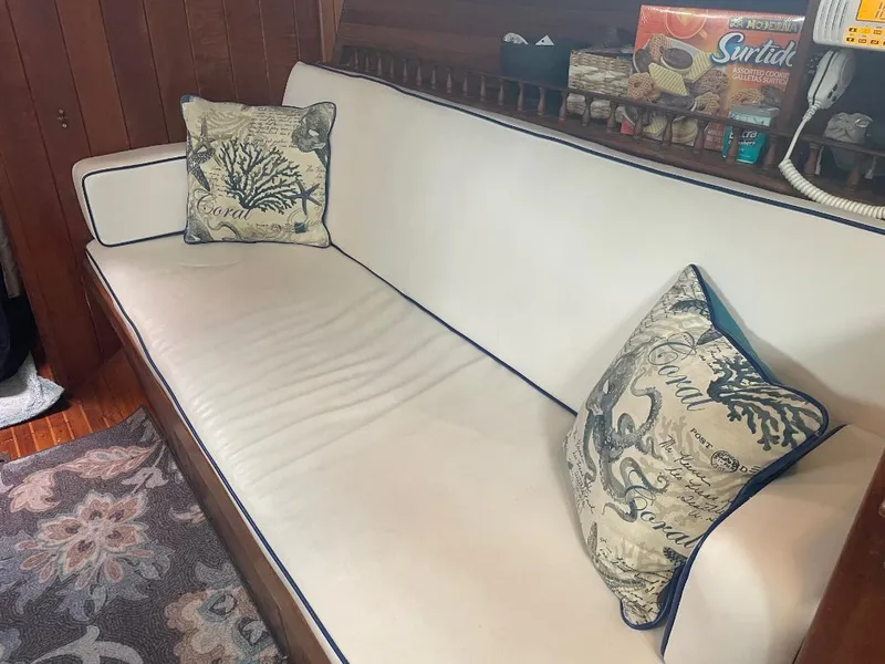 Slide: The Image of Cozy interior of 1979 C & L Explorer Center Cockpit Cutter with nautical-themed cushions. - 16