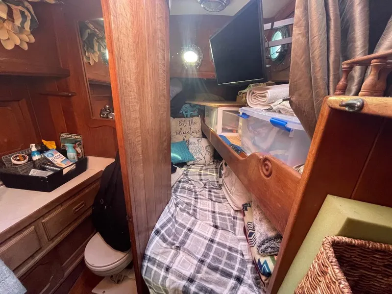 Slide: The Image of 1979 C & L Explorer Center Cockpit Cutter cabin with bed, storage, and nautical decor. - 17