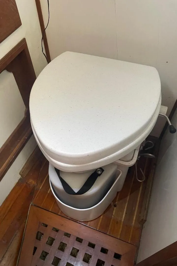 Slide: The Image of 1979 C & L Explorer Center Cockpit Cutter marine toilet on wooden floor. - 20