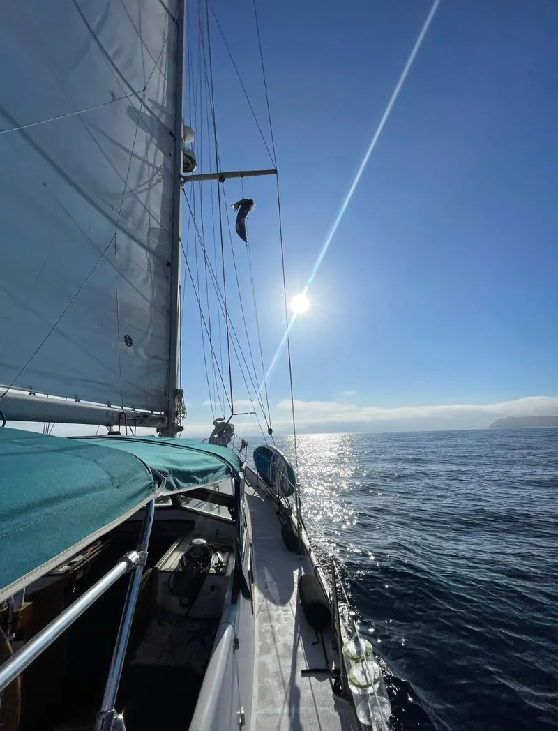 Slide: The Image of 1979 C & L Explorer Center Cockpit Cutter sailing under clear blue sky. - 23