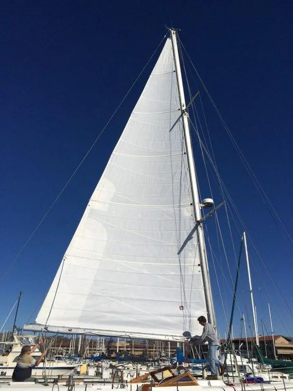 Slide: The Image of 1979 C & L Explorer Center Cockpit Cutter sailboat with white sails against a clear blue sky. - 27