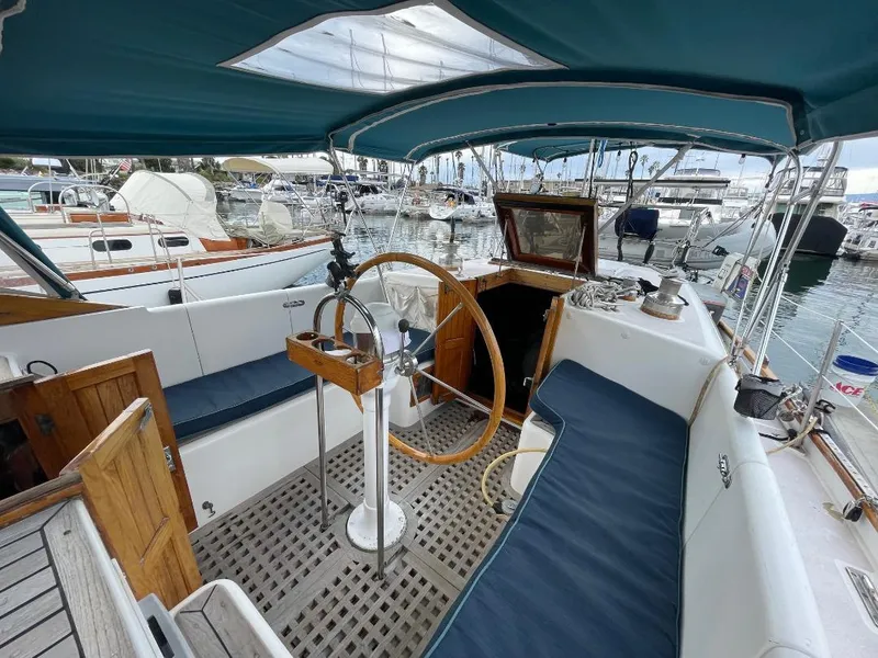 Slide: The Image of 1979 C & L Explorer Center Cockpit Cutter with wooden wheel, docked in marina. - 3