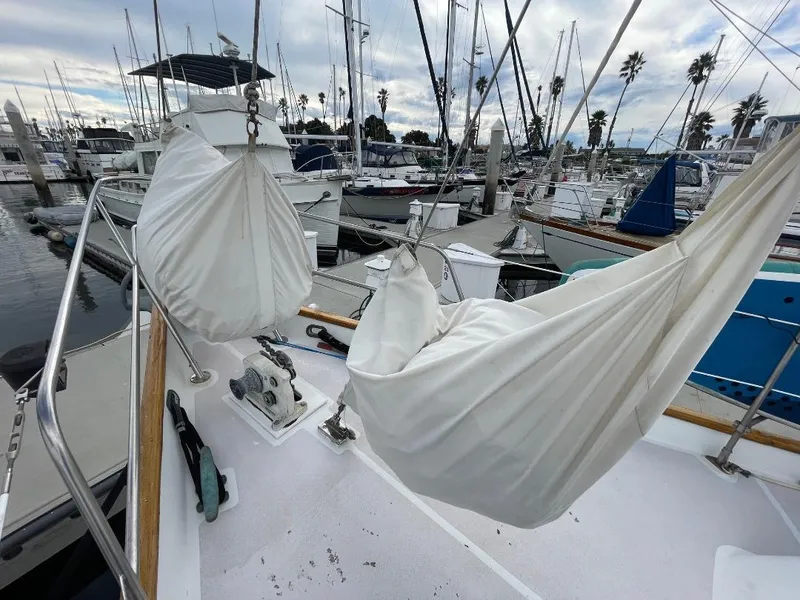 Slide: The Image of 1979 C & L Explorer Center Cockpit Cutter with hammocks on deck, docked at marina. - 39