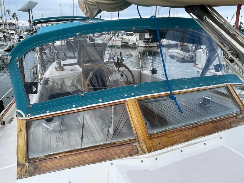 Slide: The Image of 1979 C & L Explorer Center Cockpit Cutter with blue canopy in marina setting. - 4