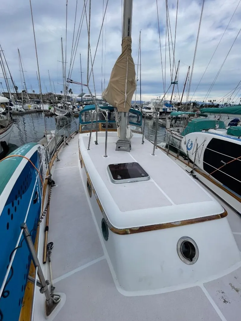 Slide: The Image of 1979 C & L Explorer Center Cockpit Cutter docked in a marina, surrounded by other boats. - 40