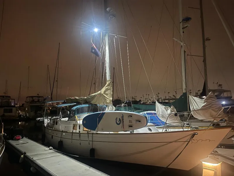 Slide: The Image of 1979 C & L Explorer Center Cockpit Cutter sailboat docked at night, illuminated by marina lights. - 41