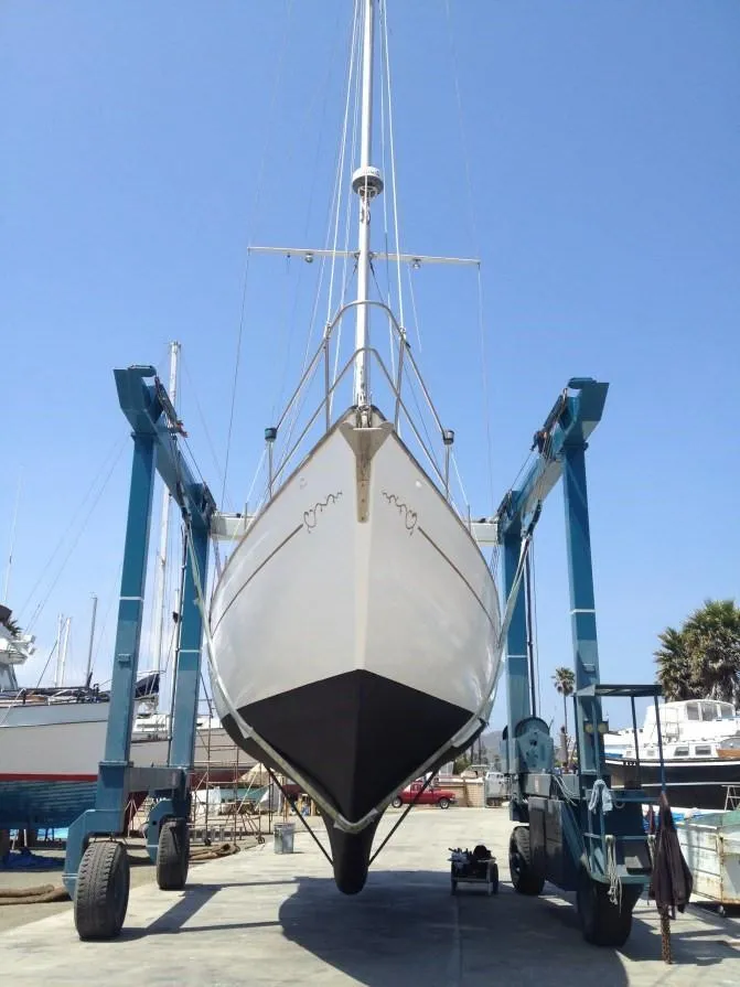 Slide: The Image of 1979 C & L Explorer Center Cockpit Cutter sailboat in dry dock, viewed from the front. - 8