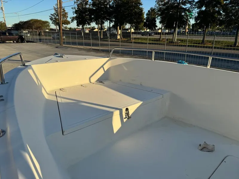 Slide: The Image of 2004 Sea Boss 190 Center Console boat interior, spacious deck with storage compartments. - 10