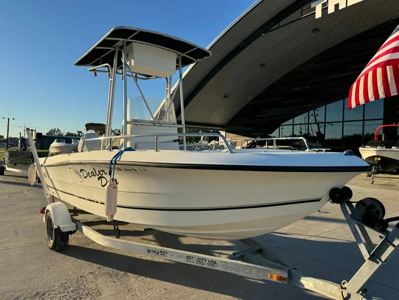 Slide: The Image of 2004 Sea Boss 190 Center Console boat on trailer, American flag in background. - 5