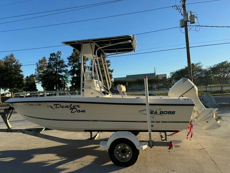 Slide: The Image of 2004 Sea Boss 190 Center Console boat on trailer, side view, sunny day. - 9