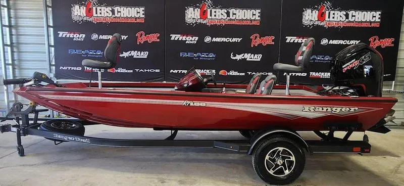 The Image of 2025 Ranger RT188 boat in showroom, red color, on trailer, Anglers Choice backdrop. - 1