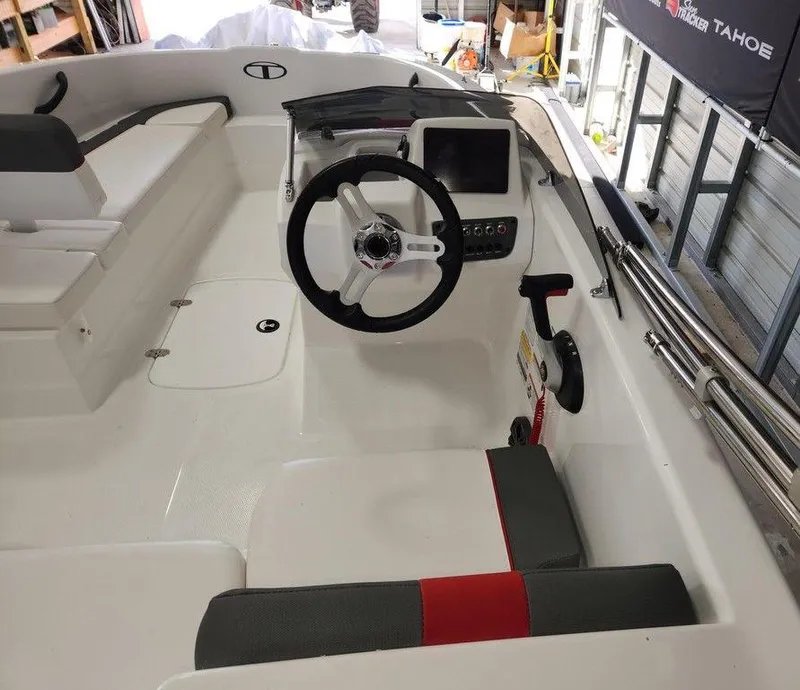 Slide: The Image of 2025 Tahoe T16 boat interior with steering wheel and dashboard controls. - 5