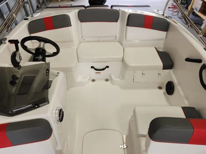 Slide: The Image of 2025 Tahoe T16 boat interior with red and gray seating, steering wheel, and controls. - 7