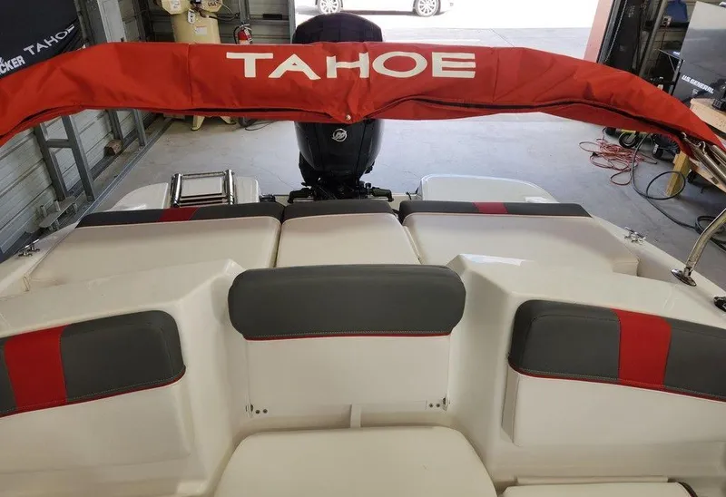 Slide: The Image of 2025 Tahoe T16 boat interior with red and gray seating, rear view. - 9