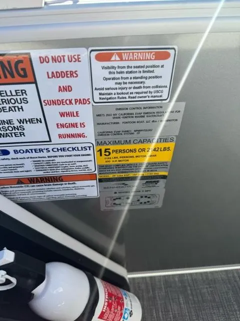 Slide: The Image of 2024 Bennington 25 QFB safety warnings and capacity limits displayed on boat interior. - 16