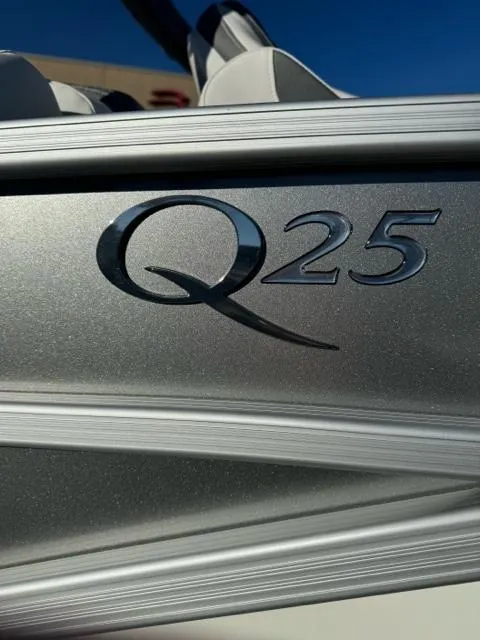 Slide: The Image of 2024 Bennington 25 QFB boat logo on metallic surface. - 2