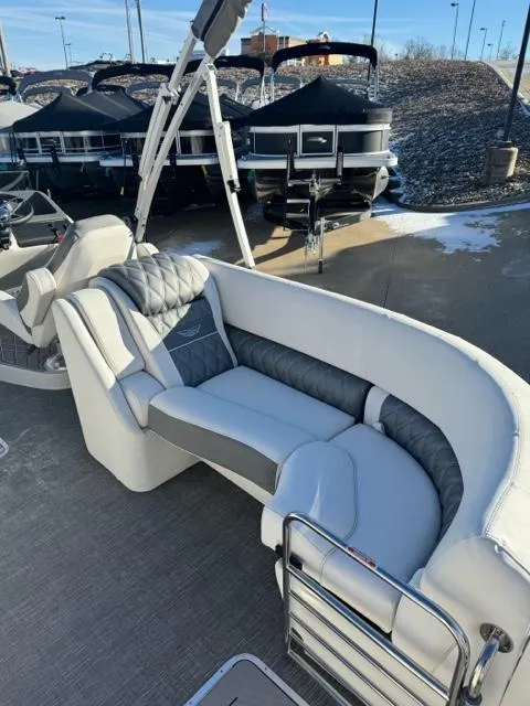Slide: The Image of 2024 Bennington 25 QFB luxury pontoon boat with plush seating and modern design. - 8