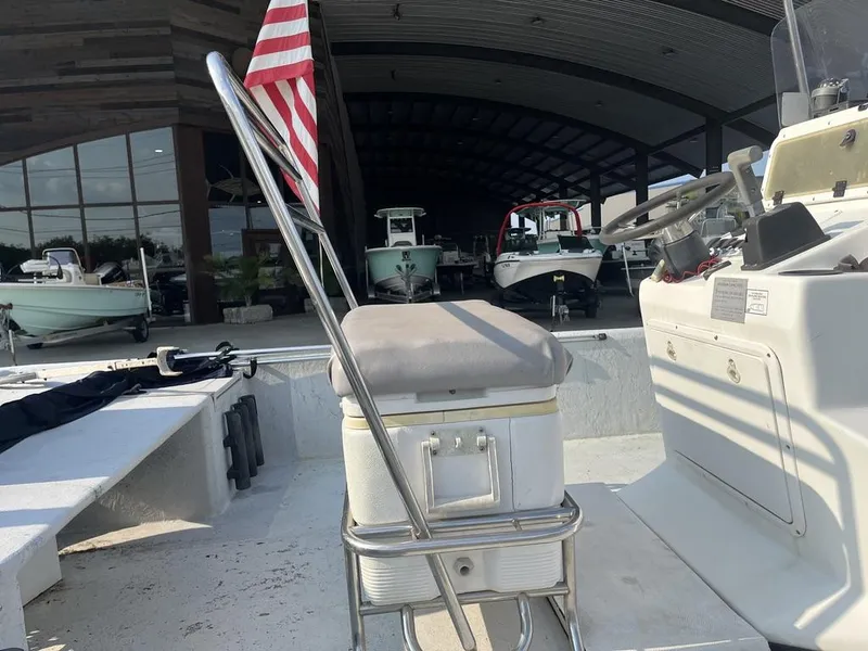 Slide: The Image of 2002 Champion 230-RV boat in a marina under a clear blue sky. - 10