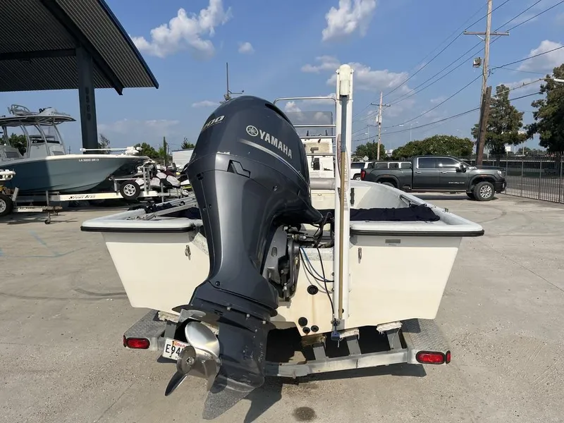 Slide: The Image of 2002 Champion 230-RV boat deck with trolling motor and seat in parking lot. - 15