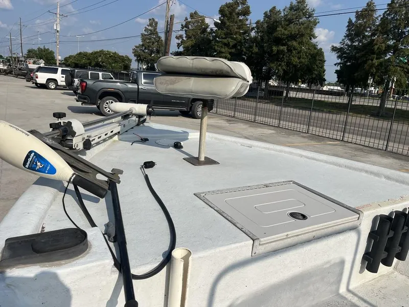 Slide: The Image of 2002 Champion 230-RV boat, center console view, parked outdoors on a sunny day. - 16