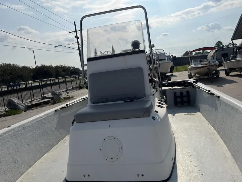 Slide: The Image of 2002 Champion 230-RV boat interior with seating and steering console. - 17