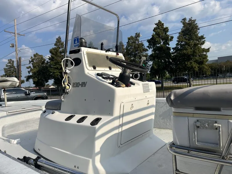 Slide: The Image of 2002 Champion 230-RV boat in a marina, featuring a central console and seating. - 19