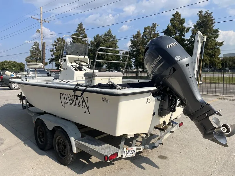 Slide: The Image of 2002 Champion 230-RV boat on trailer with Yamaha outboard motor. - 5