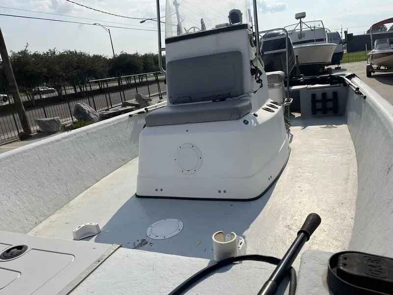 Slide: The Image of Interior of a 2002 Champion 230-RV boat with seating and motor. - 7