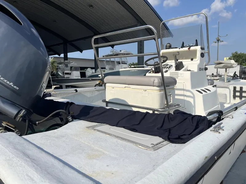 Slide: The Image of 2002 Champion 230-RV boat interior with American flag, docked in a marina. - 9