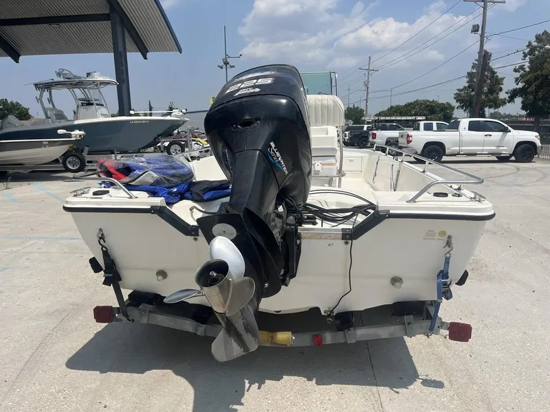 Slide: The Image of 2000 Robalo boat with outboard motor on trailer in parking lot. - 10