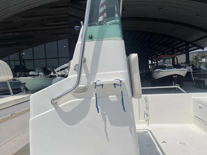 Slide: The Image of 2000 Robalo boat interior with steering console and seating, in a covered storage area. - 15