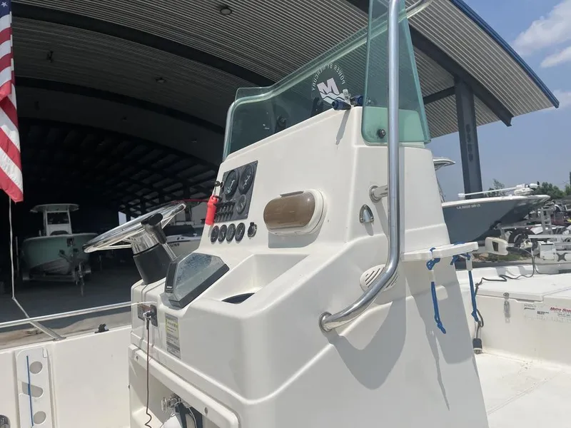 Slide: The Image of Center console of a 2000 Robalo boat with steering wheel and controls. - 5