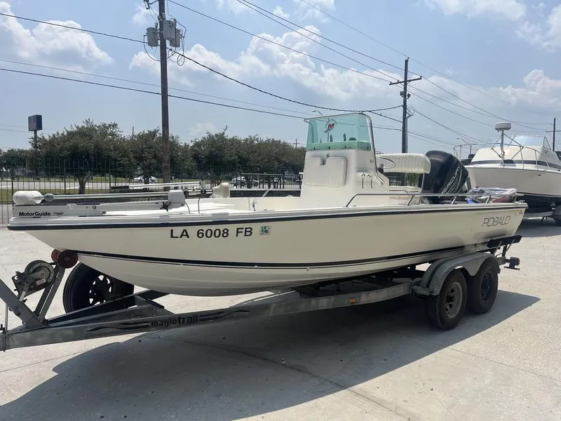 Slide: The Image of 2000 Robalo boat on trailer, parked outdoors under a cloudy sky. - 6