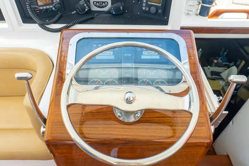 Slide: The Image of 1993 Buddy Davis Express Custom Carolina boat helm with wooden steering wheel and control panel. - 13