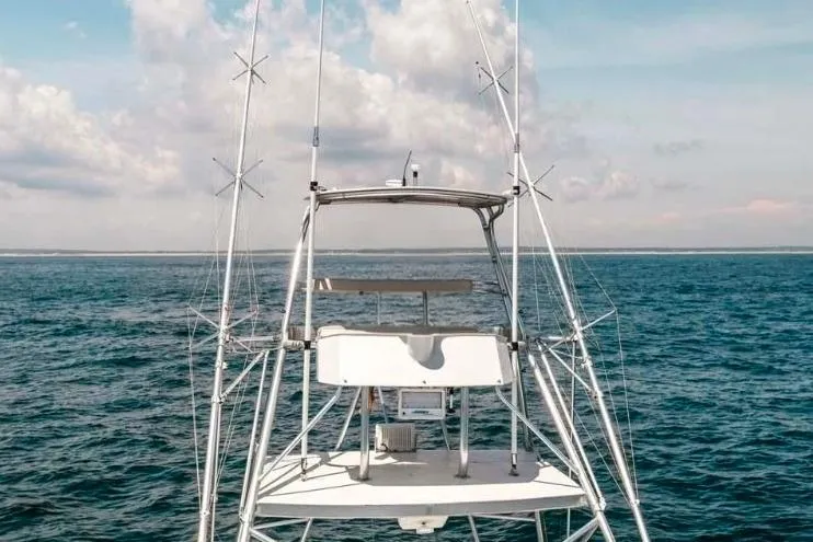 Slide: The Image of 1993 Buddy Davis Express Custom Carolina boat on open sea under blue sky. - 16