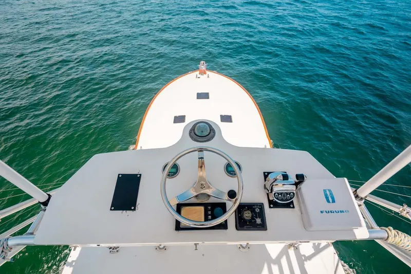 Slide: The Image of Helm view of 1993 Buddy Davis Express Custom Carolina boat on open water. - 17